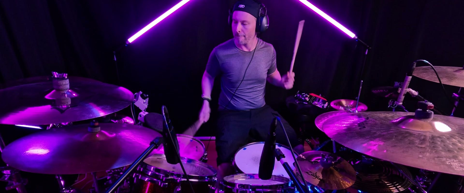 Josh Holland playing drums in his studio